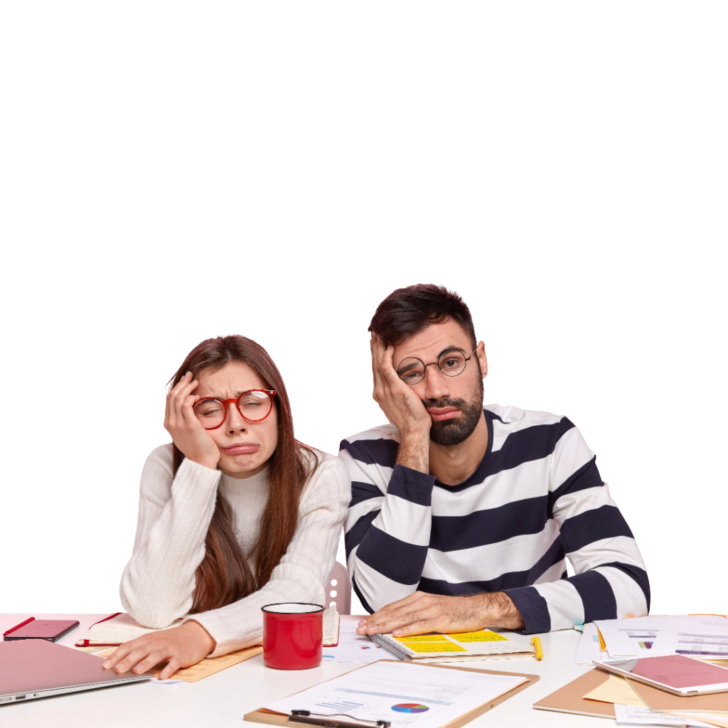 coworkers sitting desk with documents gadgets